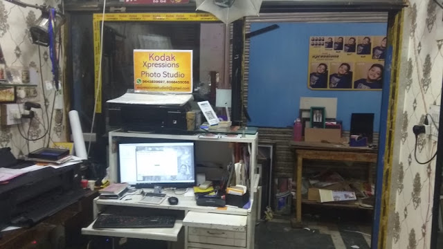 Workstation with printer and the passport photo backdrop inside the studio