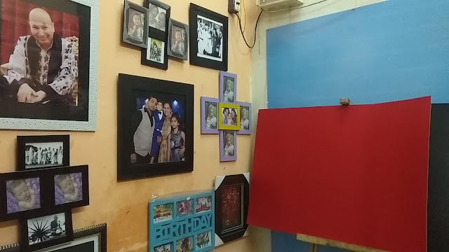 A wall of framed photographs inside the studio