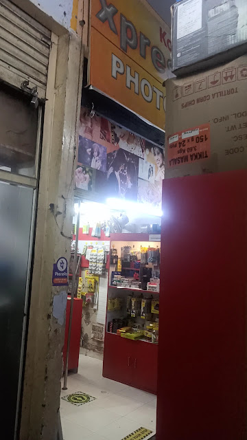 The shopfront at night, lit from inside