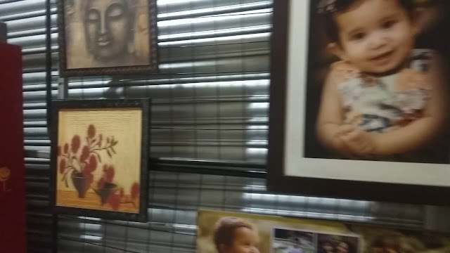 Framed prints resting against the studio wall