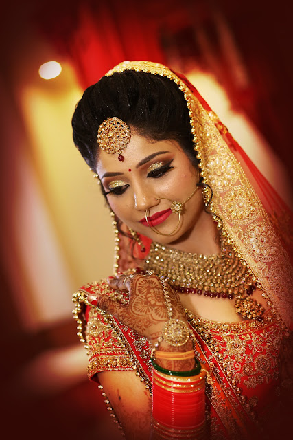 Close portrait of a bride in red, lit warmly